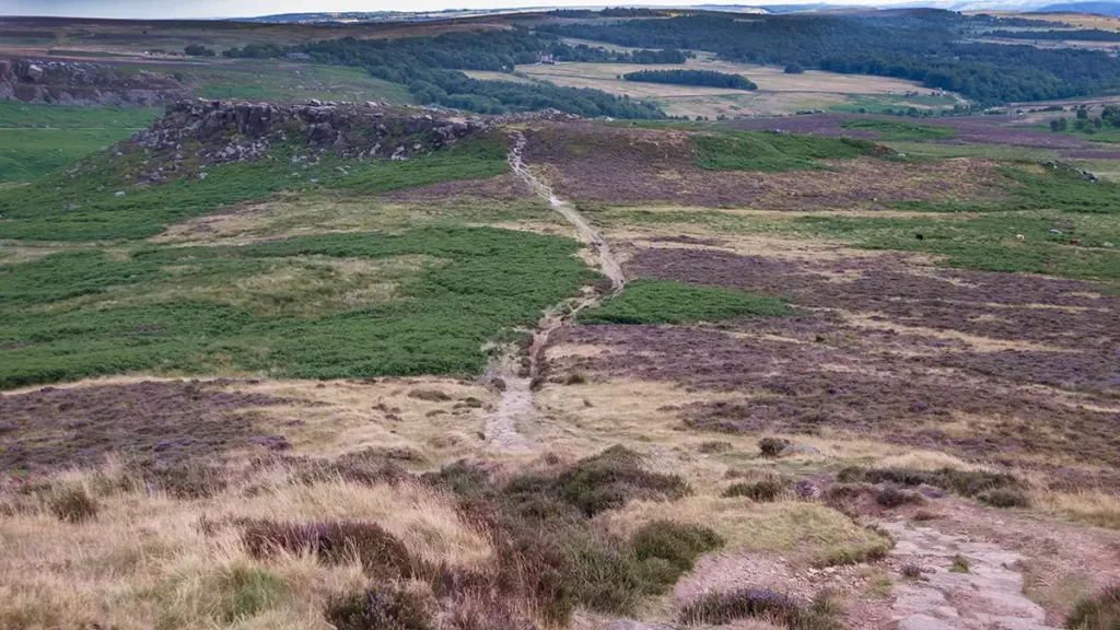 A clear path heads across the moorland to the promontory of Carl Wark