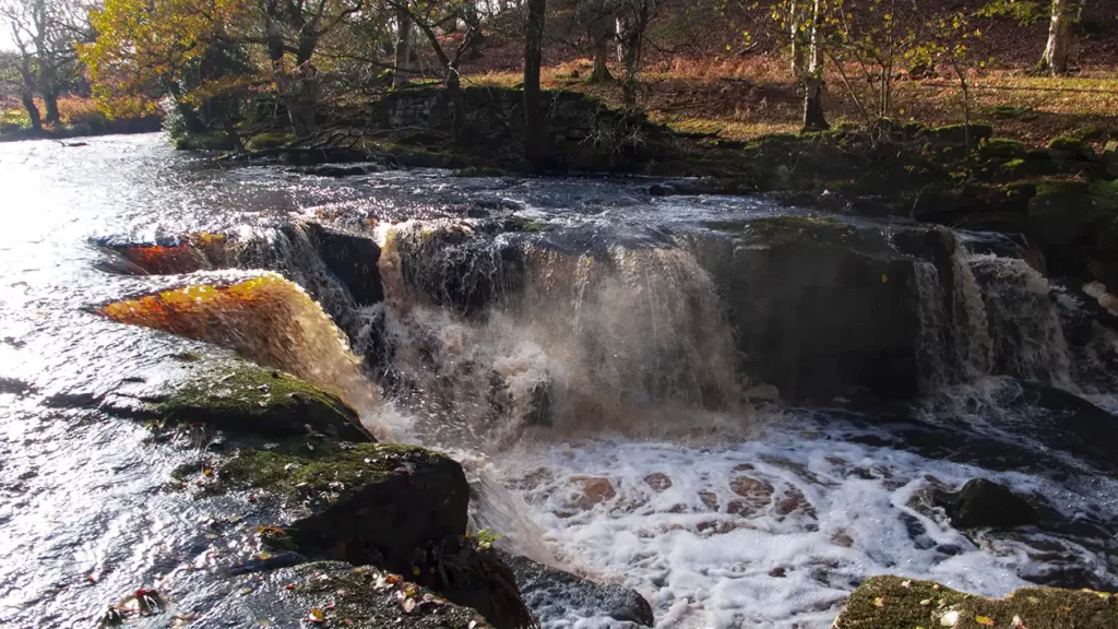 Water rushes over the rocks of Nelly Ayre Foss near Goathland in the North York Moors